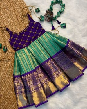 Product Title: Purple & Teal Green Sleeveless Pattu Frock with Hair Accessory – Tiny Pattu Designer Festive Wear